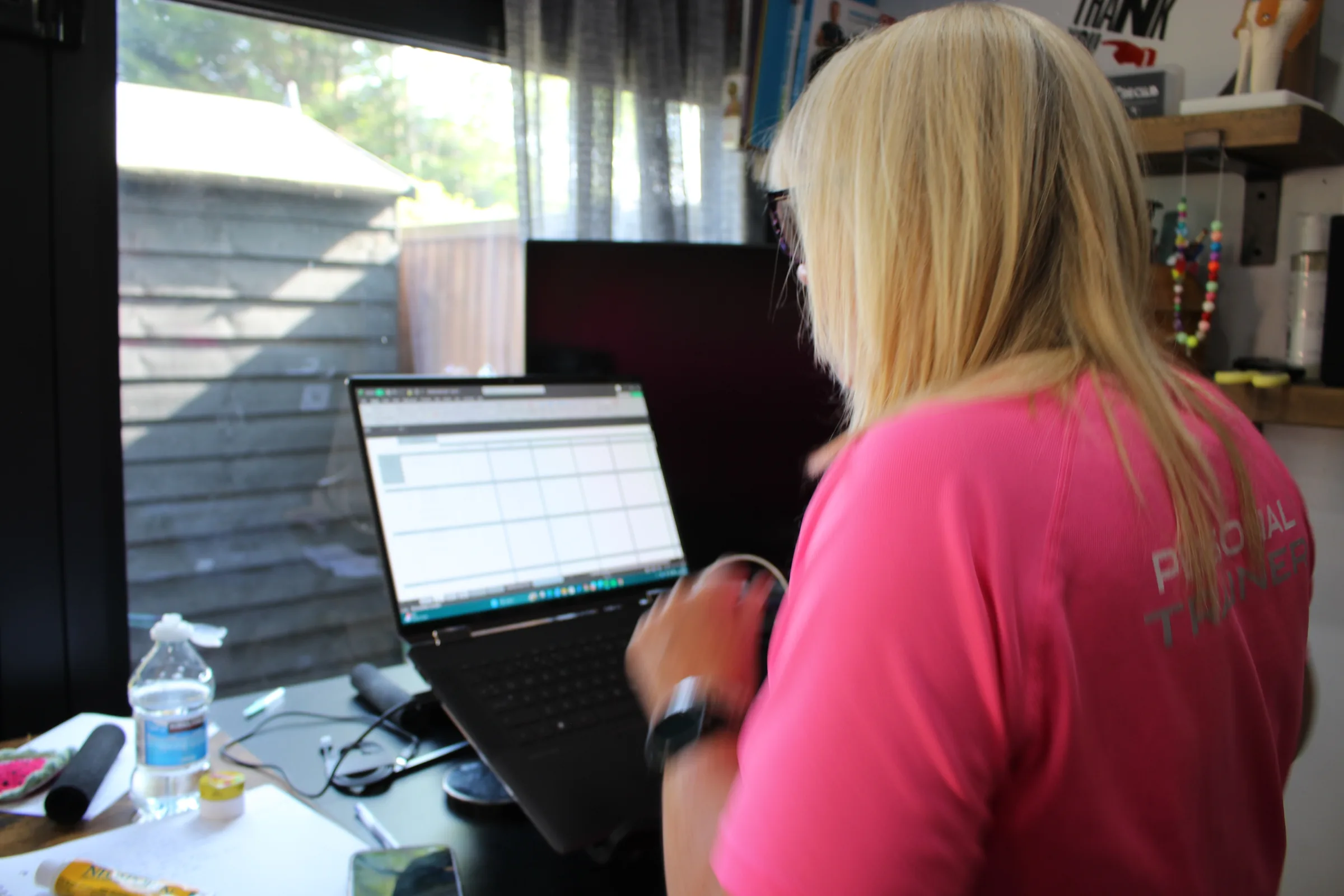 Carol at her laptop, writing a training programme.